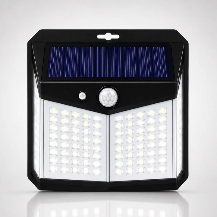 A solar-powered outdoor wall light with a black housing, a blue solar panel on top, a white motion sensor, and multiple bright LED light panels on the front, shown against a light gray background.